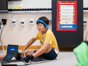 Jose, a rising third-grader, uses a laptop to work on math problems at the Dreamcatchers summer learning program at Susan Moore Elementary School in Blount County, Alabama. Photo by Bita Honarvar for FHI 360.