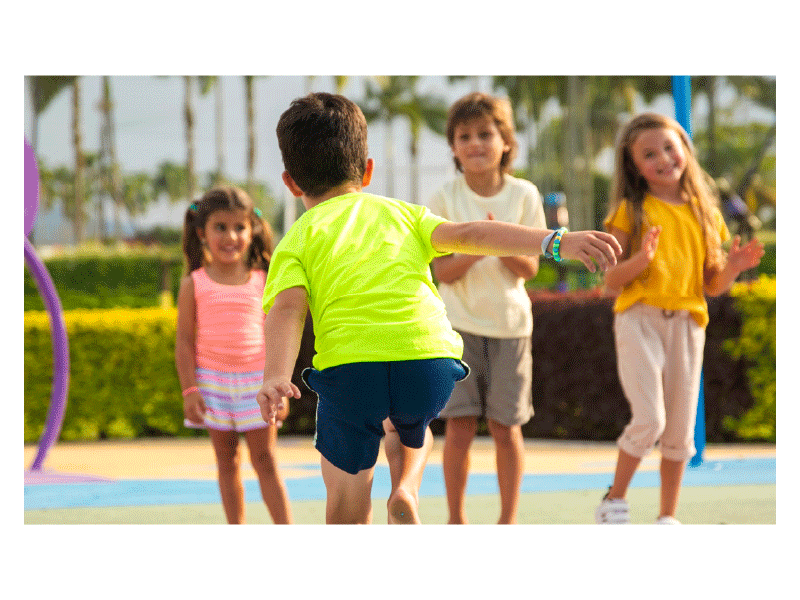 Three kids watch another kid do hopscotch. Yellow, orange, and purple stars and light orange rays pop onto the image as the gif plays.