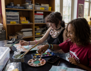 Seventh grade students Tessa Daniels (left) and Oliver Gollate (right) paint during art class on Sept. 20th, 2022. Photo credit: Jessica Scranton for FHI 360.