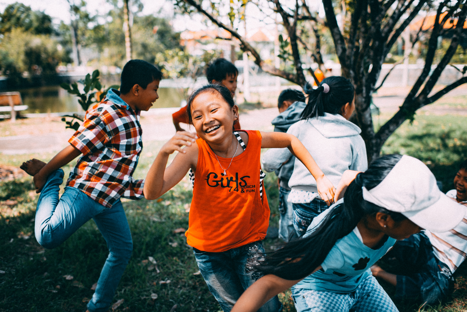 A group of diverse children run and play